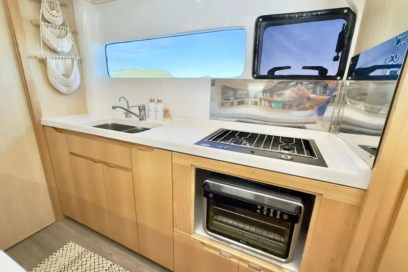 Slide: The Image of Modern kitchen in 2023 Seawind 1170 yacht with stove, sink, and oven. - 35