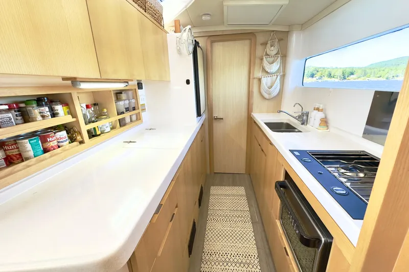 Slide: The Image of Modern kitchen interior of 2023 Seawind 1170 yacht with sleek countertops and appliances. - 37
