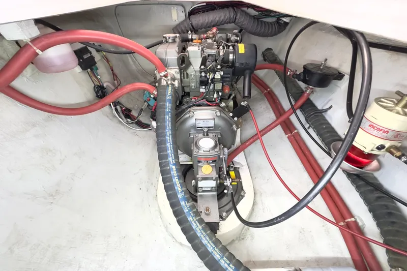 Slide: The Image of Engine compartment of a 2023 Seawind 1170 catamaran, showcasing mechanical components and wiring. - 38