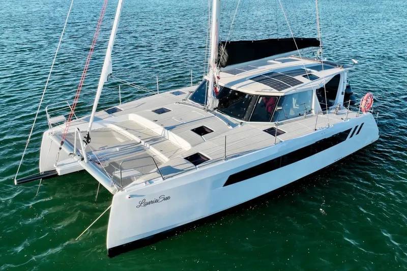 Slide: The Image of 2023 Seawind 1170 catamaran sailing on calm blue waters. - 6