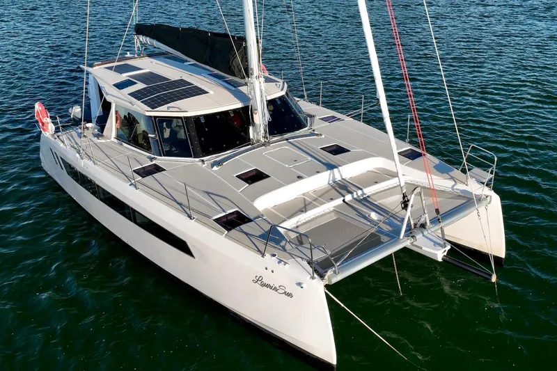 Slide: The Image of 2023 Seawind 1170 catamaran sailing on calm waters, showcasing sleek design and solar panels. - 8