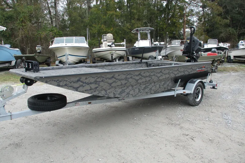 The Image of 2026 Gator Tail 1754 Extreme boat on trailer, surrounded by other boats. - 1