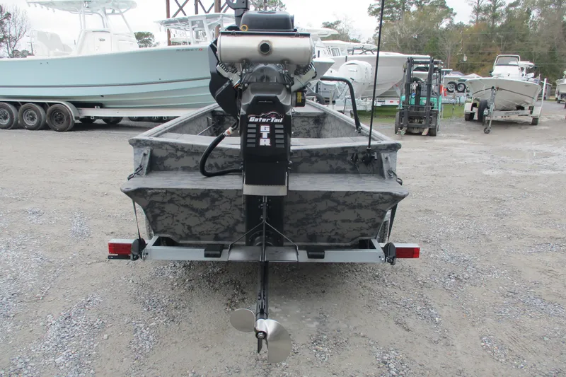 Slide: The Image of 2026 Gator Tail 1754 Extreme boat with motor, parked on gravel lot. - 4