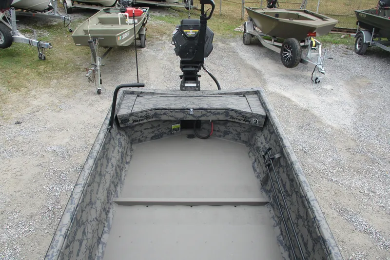 Slide: The Image of 2026 Gator Tail 1754 Extreme boat with camouflage interior, parked on gravel. - 6