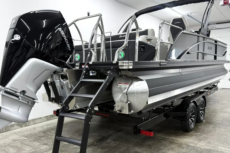 Slide: The Image of 2026 Barletta CORSA 25UC pontoon boat with Mercury outboard engine in a showroom. - 10