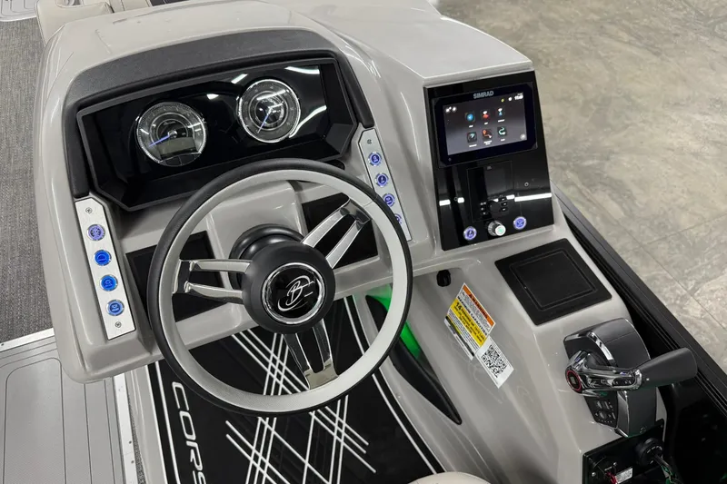 Slide: The Image of 2026 Barletta CORSA 25UC boat dashboard with steering wheel and digital controls. - 30