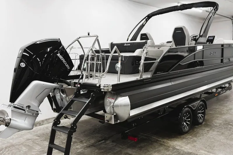 Slide: The Image of 2026 Barletta CORSA 25UC pontoon boat with Mercury engine, displayed indoors on a trailer. - 9