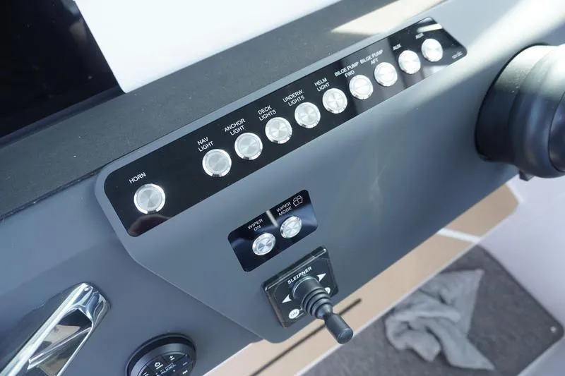 Slide: The Image of Control panel of 2025 Axopar 29 XC Cross Cabin boat with labeled buttons and switches. - 11