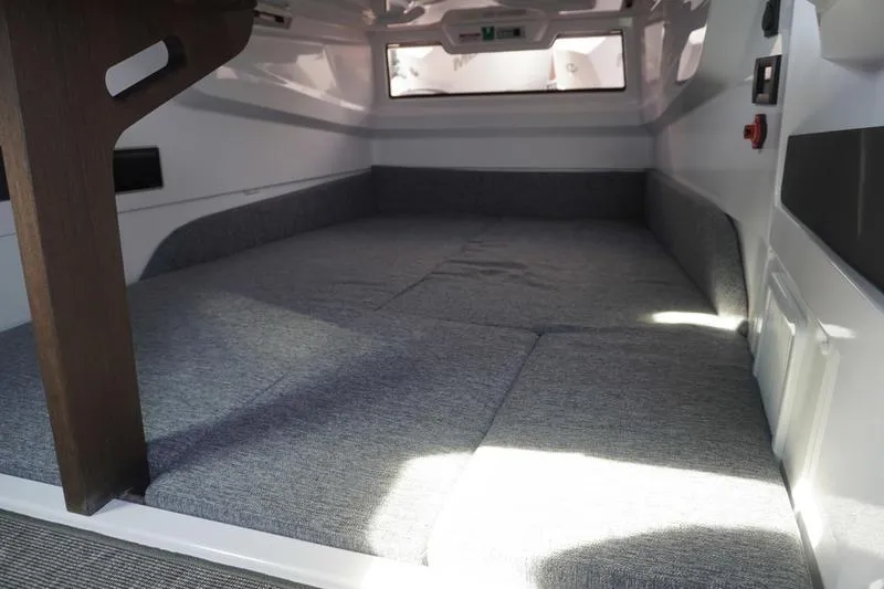 Slide: The Image of 2025 Axopar 29 XC Cross Cabin interior with spacious sleeping area and modern design. - 14