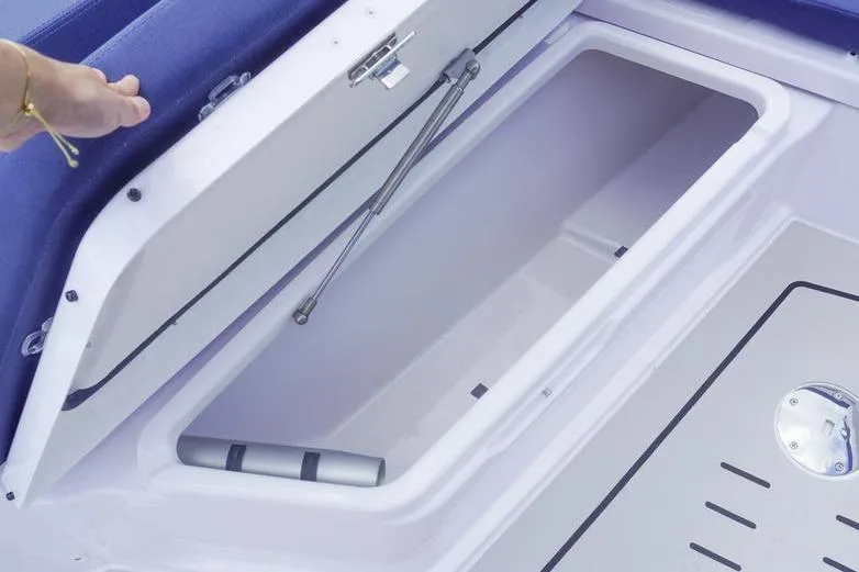 Slide: The Image of Storage compartment in 2025 Axopar 29 XC Cross Cabin boat, featuring hydraulic lift support. - 19