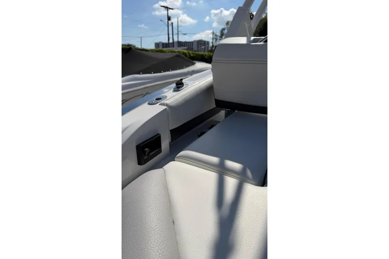 Slide: The Image of 2022 Cobalt R4 boat interior with white leather seating and control panel. - 10