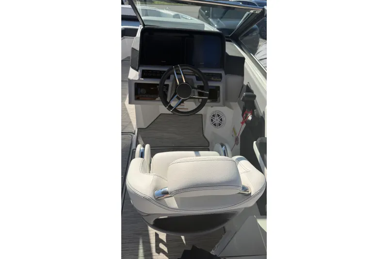 Slide: The Image of 2022 Cobalt R4 boat cockpit with steering wheel and white captain's chair. - 5