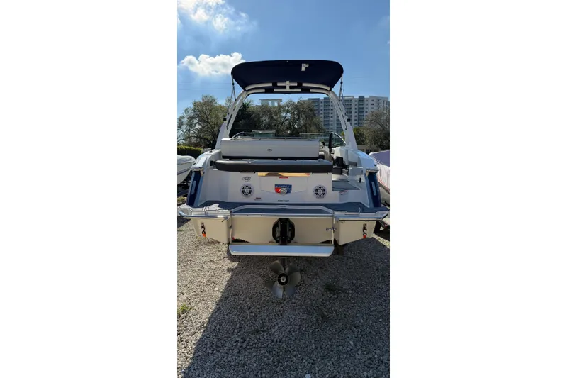 Slide: The Image of 2022 Cobalt R4 boat rear view with canopy, parked on gravel. - 6