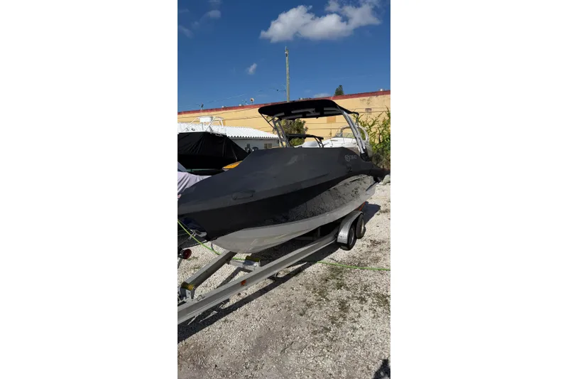 Slide: The Image of 2022 Cobalt R4 boat on trailer, covered, under clear blue sky. - 7