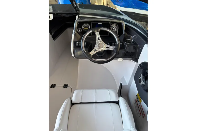 Slide: The Image of 2024 Monterey M-225 boat cockpit with steering wheel and dashboard controls. - 2