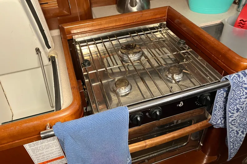 Slide: The Image of Galley stove in 2005 Beneteau Oceanis 423 sailboat kitchen, with towels hanging. - 10