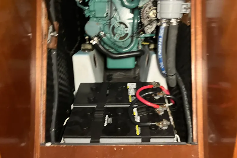 Slide: The Image of Engine compartment of a 2005 Beneteau Oceanis 423 sailboat, featuring battery and wiring. - 27