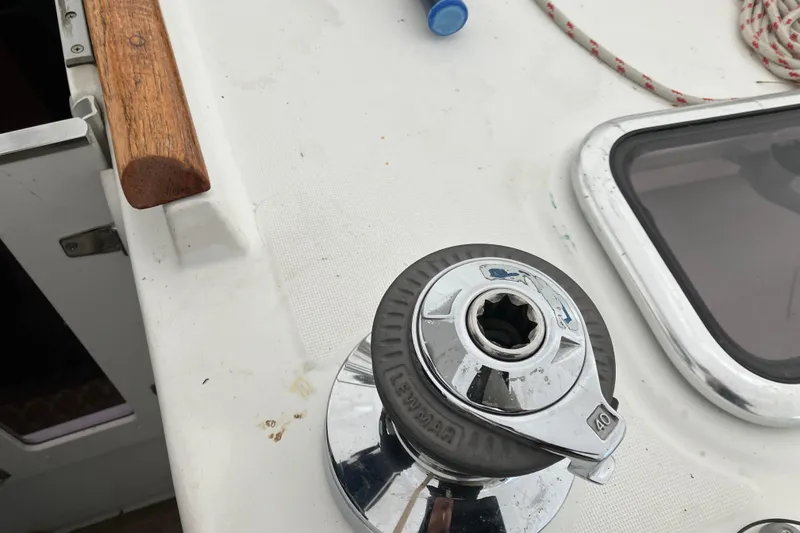 Slide: The Image of Winch on 2005 Beneteau Oceanis 423 sailboat deck with wooden handle and rope. - 42