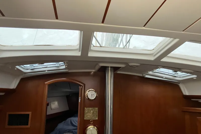 Slide: The Image of Interior view of 2005 Beneteau Oceanis 423 sailboat with skylights and wooden paneling. - 2