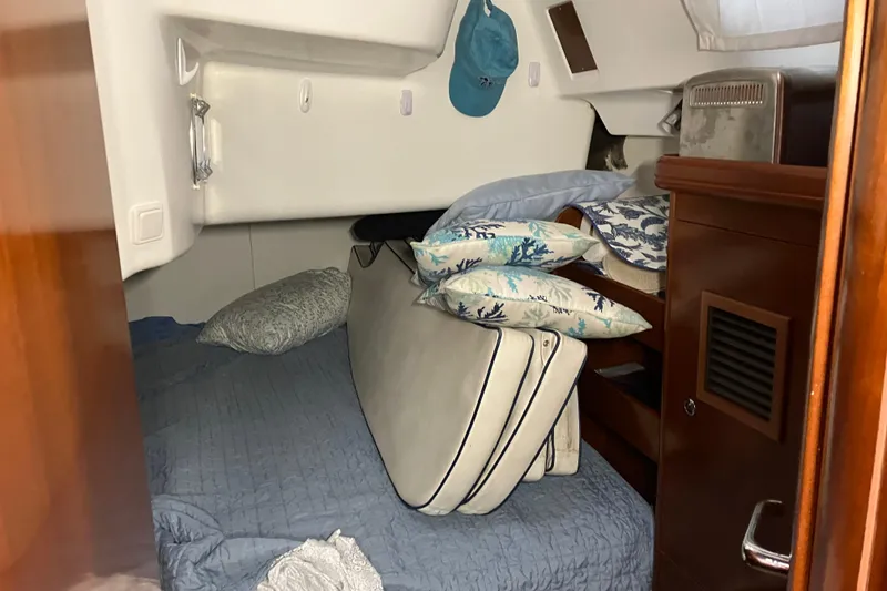 Slide: The Image of Cozy cabin interior of 2005 Beneteau Oceanis 423 with bedding and cushions. - 11