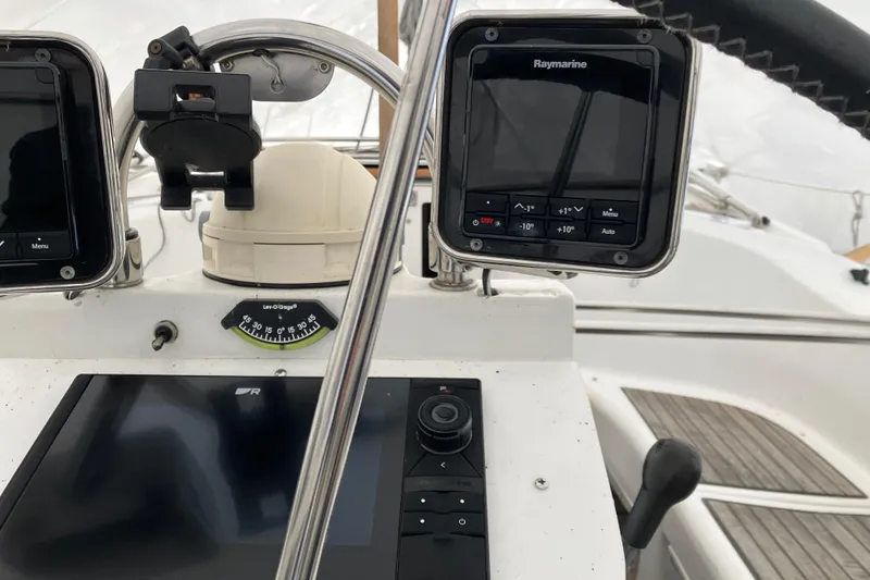 Slide: The Image of Cockpit instruments of a 2005 Beneteau Oceanis 423 sailboat, featuring Raymarine displays. - 48