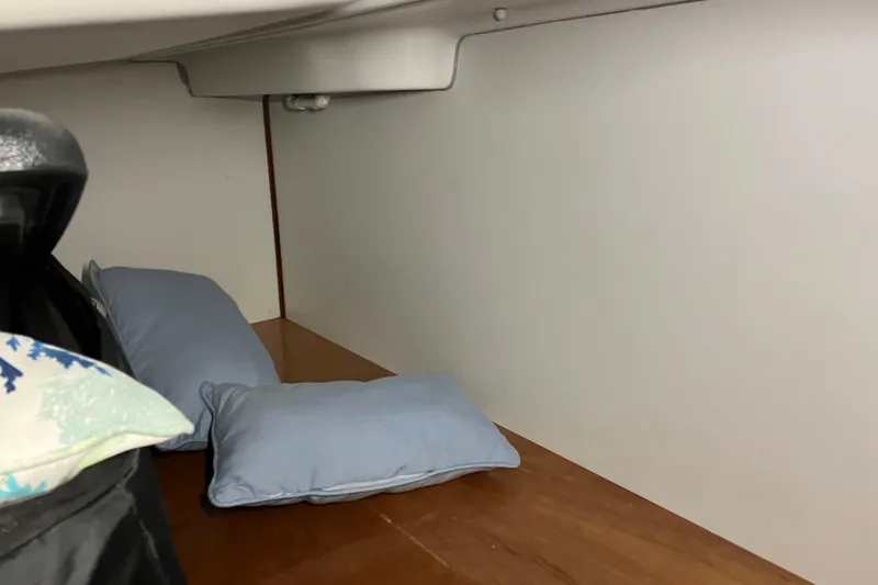 Slide: The Image of Cozy cabin interior of 2005 Beneteau Oceanis 423 with pillows and wooden flooring. - 36