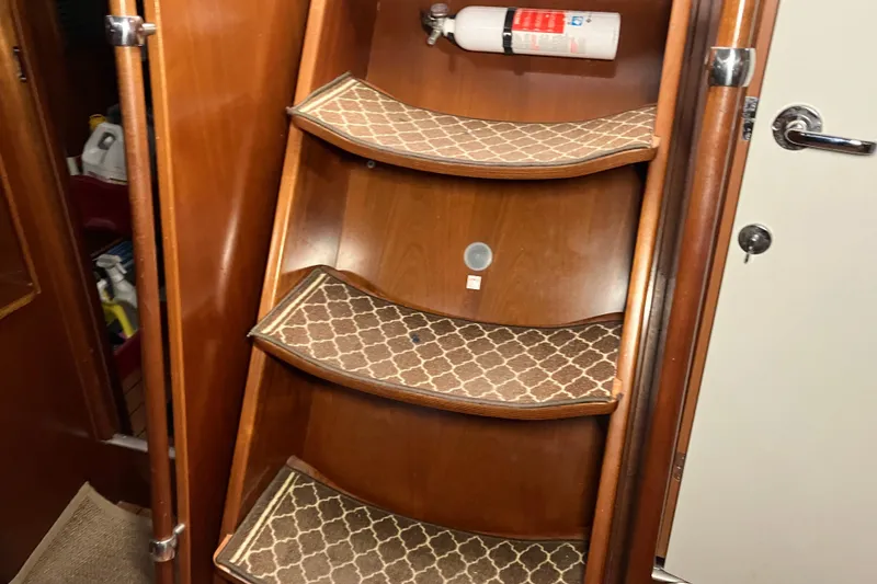 Slide: The Image of Wooden interior stairs of 2005 Beneteau Oceanis 423 yacht with patterned carpet. - 38
