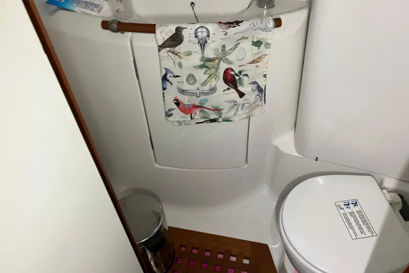 Slide: The Image of Bathroom of 2005 Beneteau Oceanis 423 yacht with bird-themed towel and wooden floor mat. - 16