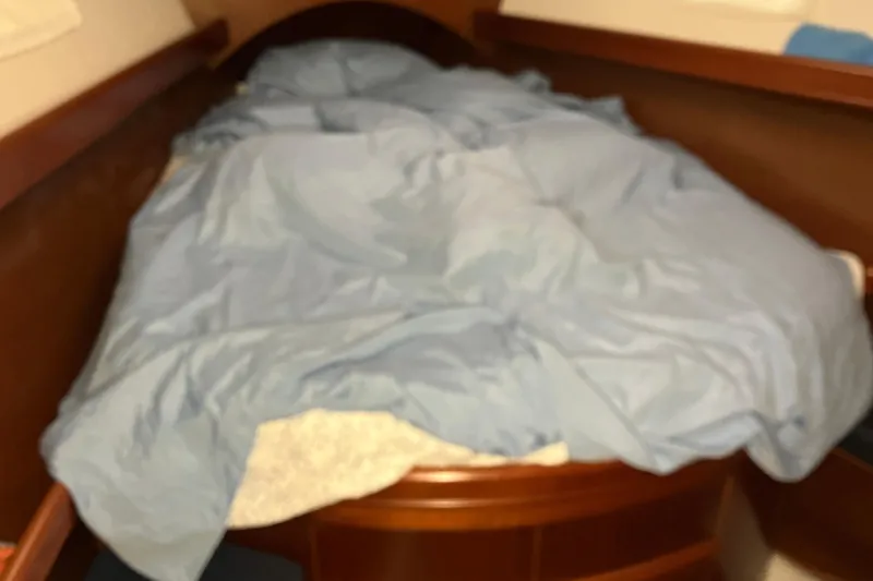 Slide: The Image of Cozy cabin bed with blue bedding on 2005 Beneteau Oceanis 423 sailboat. - 7