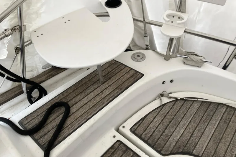 Slide: The Image of Cockpit of 2005 Beneteau Oceanis 423 sailboat with wooden flooring and white fixtures. - 45
