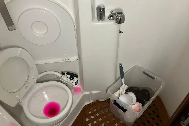 Slide: The Image of Bathroom of 2005 Beneteau Oceanis 423 sailboat with toilet and cleaning supplies. - 13