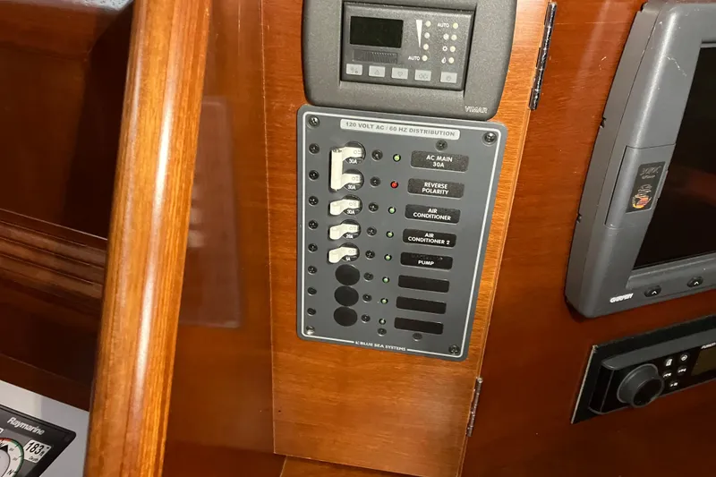 Slide: The Image of Electrical panel on 2005 Beneteau Oceanis 423 yacht, featuring various switches and controls. - 26