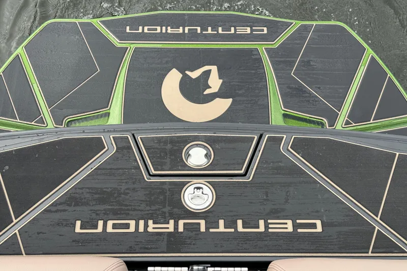 Slide: The Image of 2026 Centurion Ri245 boat deck with green accents and logo on water. - 10