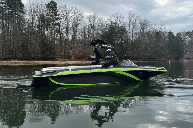 Slide: The Image of 2015 Centurion Enzo FS44 boat on calm lake with forested shoreline. - 10