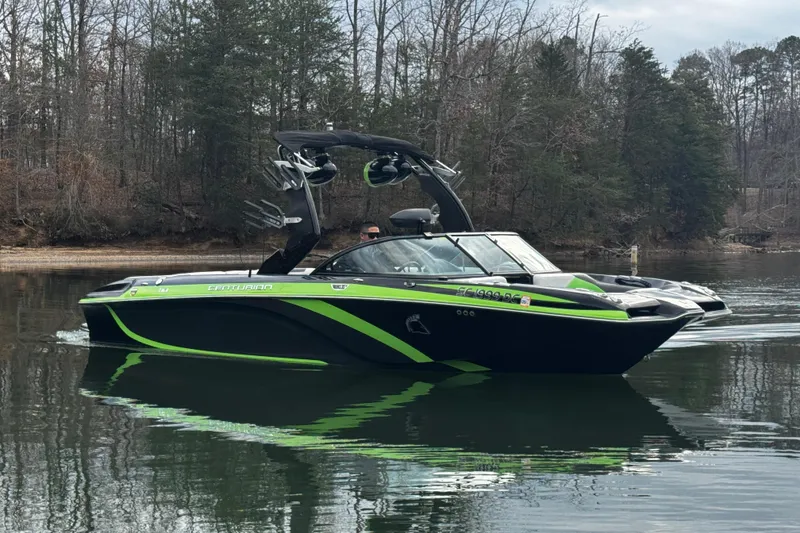 Slide: The Image of 2015 Centurion Enzo FS44 boat on calm lake with forested background. - 12