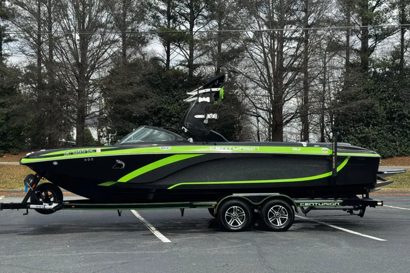 Slide: The Image of 2015 Centurion Enzo FS44 boat with green and black design on a trailer. - 14
