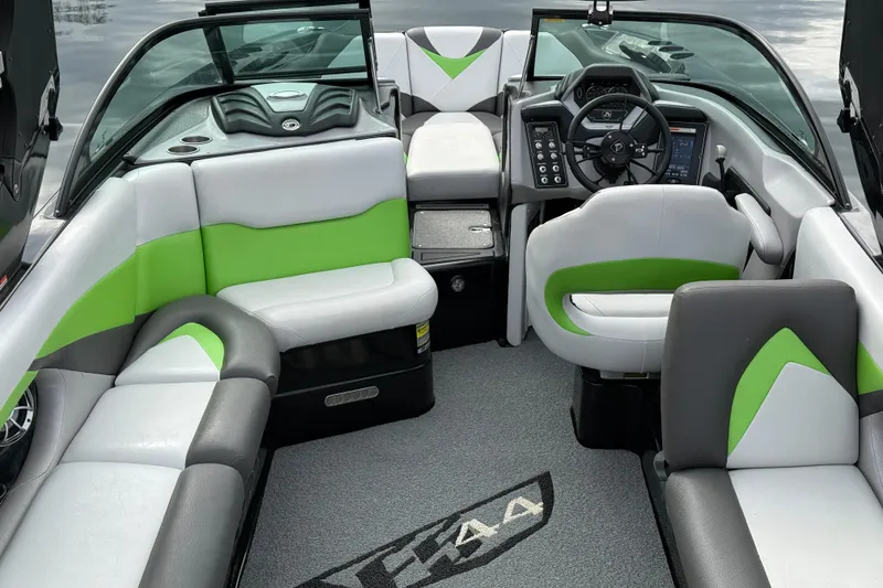 Slide: The Image of 2015 Centurion Enzo FS44 boat interior with green and gray seating, modern dashboard. - 16