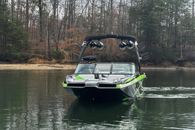 Slide: The Image of 2015 Centurion Enzo FS44 boat on calm lake with forested shoreline. - 2