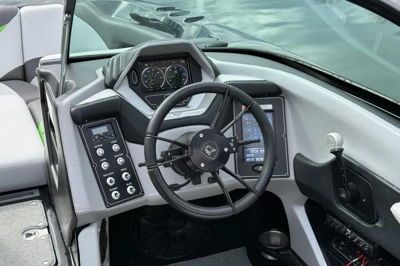 Slide: The Image of 2015 Centurion Enzo FS44 boat dashboard with steering wheel and control panel. - 22