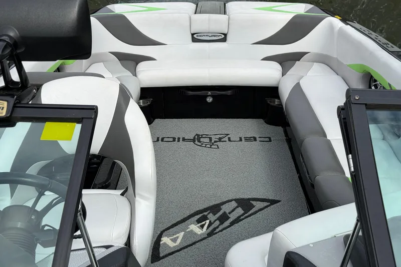 Slide: The Image of 2015 Centurion Enzo FS44 boat interior with white and gray seating, logo on carpet. - 24