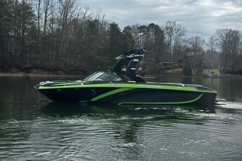 Slide: The Image of 2015 Centurion Enzo FS44 boat on a calm lake with wooded shoreline. - 5