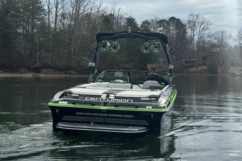 Slide: The Image of 2015 Centurion Enzo FS44 boat on a calm lake, surrounded by trees. - 8