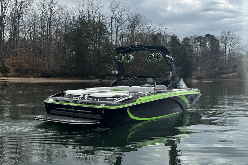 Slide: The Image of 2015 Centurion Enzo FS44 boat on a calm lake with trees in the background. - 9
