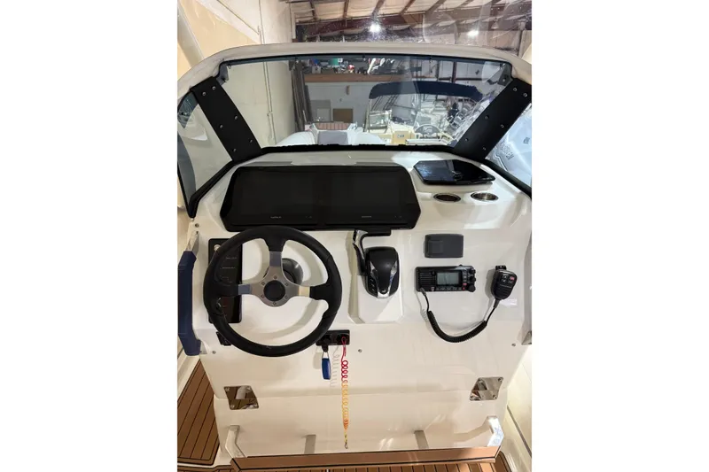 Slide: The Image of 2023 Brig Eagle 8 boat dashboard with steering wheel and navigation controls. - 4