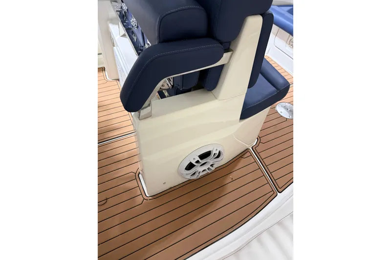 Slide: The Image of 2023 Brig Eagle 8 boat interior with blue seating and teak-style flooring. - 6