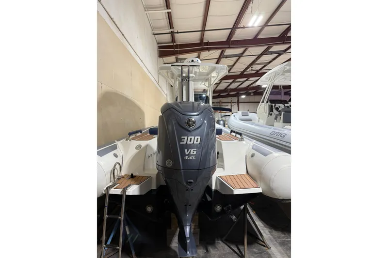 Slide: The Image of 2023 Brig Eagle 8 boat with 300 V6 engine in a warehouse setting. - 9