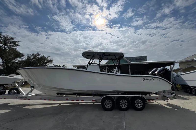 The Image of 2026 Yellowfin 34 Offshore boat on trailer under cloudy sky. - 1
