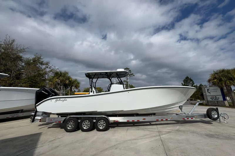 Slide: The Image of 2026 Yellowfin 34 Offshore boat on trailer under cloudy sky. - 11