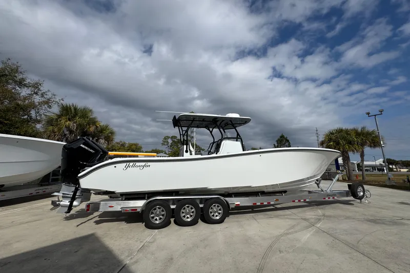 Slide: The Image of 2026 Yellowfin 34 Offshore boat on trailer under cloudy sky. - 12