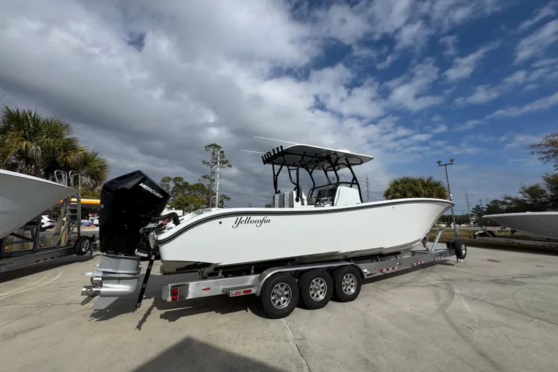 Slide: The Image of 2026 Yellowfin 34 Offshore boat on trailer under cloudy sky. - 13
